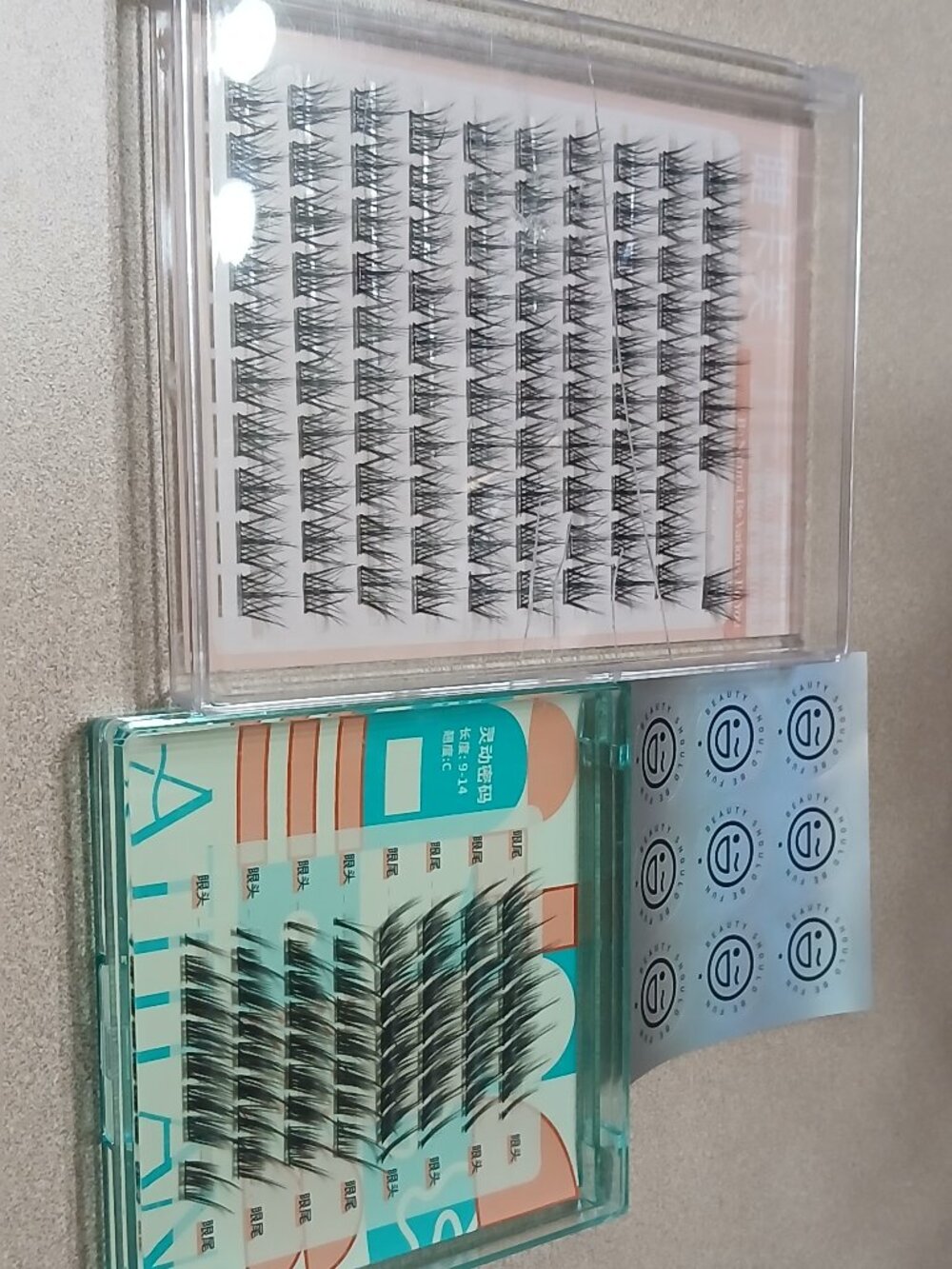 Two boxes of false eyelashes for makeup application.